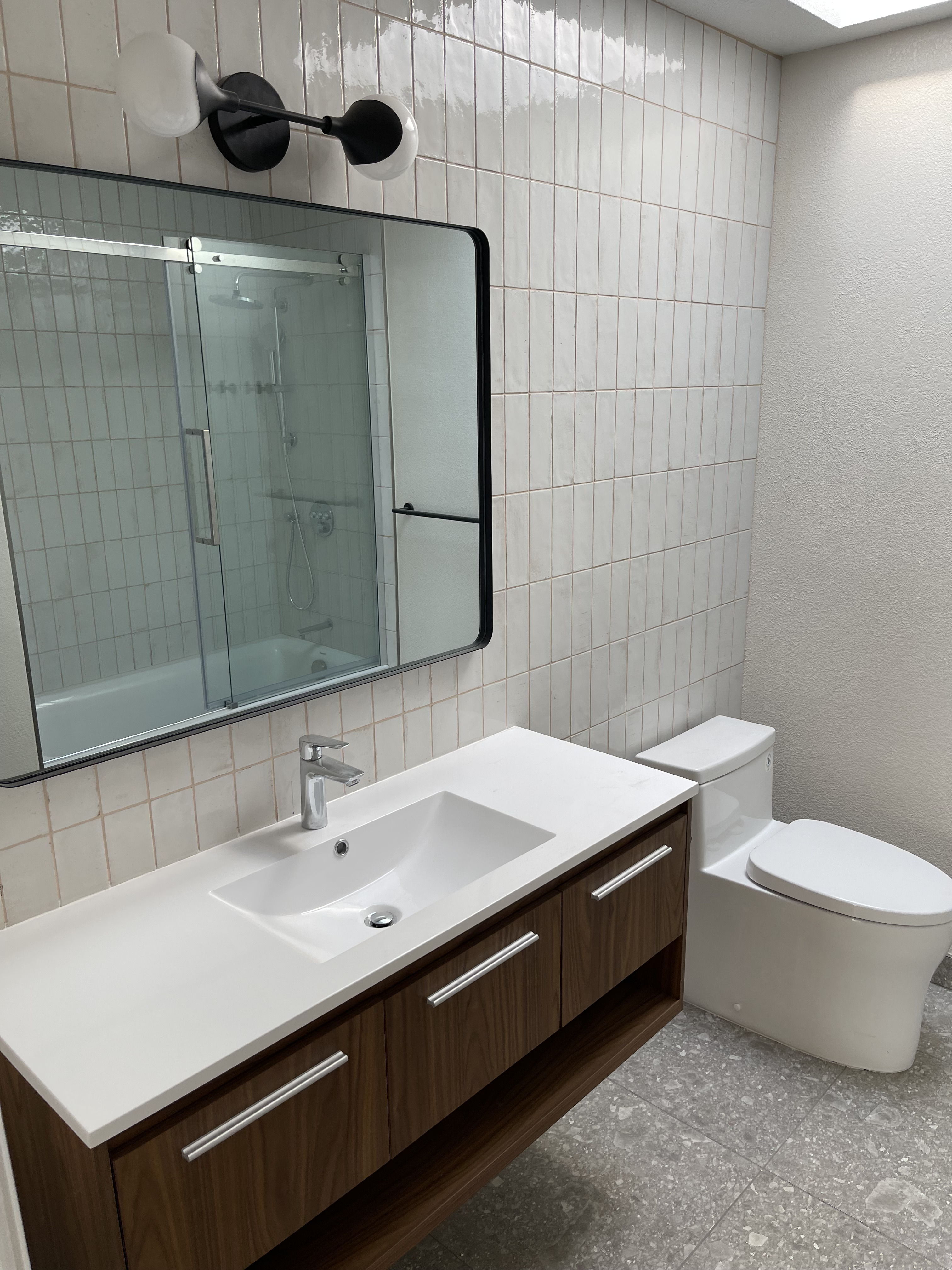 CFCC bathroom remodel · walnut vanity, vertical stack tile